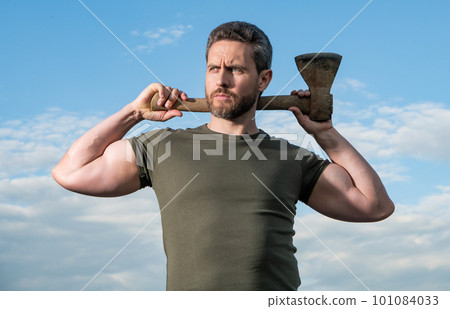 confident man with axe. lumberjack man hold ax. brutal man on sky background 101084033