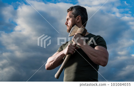 strong man with axe. brutal man hold ax. brutal man on sky background 101084035