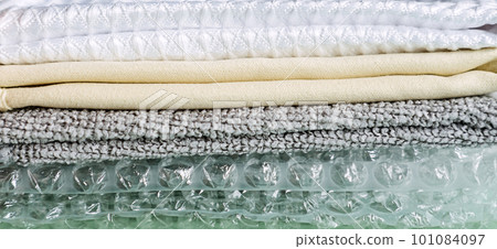 Recycling Fibers in the Textile Industry. Sustainable recycled cotton fiber. Many napkins fabrics made of recycled polyester synthetic fabric and bubble wrap Recycling Fibers in the Textile Industry. Sustainable recycled cotton fiber. Many napkins fabrics made of recycled polyester synthetic fabric and bubble wrap 101084097