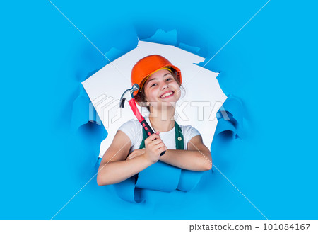Child care development. Kid engineer with carpenter work hammer. Labor day at 1 may. little girl in hard hat holds hammer. best repairer ever. learning to use hammer. hammering. she is good assistant 101084167