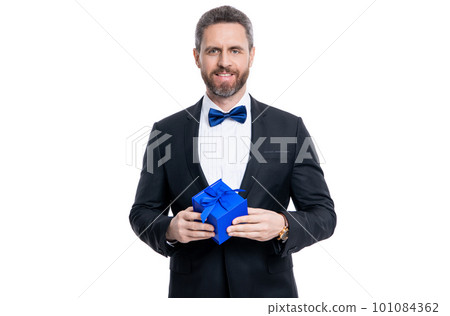 happy tuxedo man with occasion present isolated on white background. man with occasion gift happy tuxedo man with occasion present isolated on white background. man with occasion gift 101084362