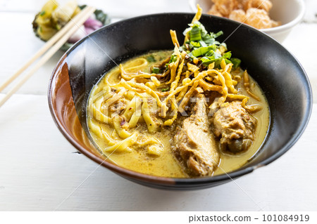 Khao soi is popular delicacy of the Northern Thailand made up of curry noodle with chicken Khao soi is popular delicacy of the Northern Thailand made up of curry noodle with chicken 101084919