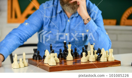 tournament skills. chess figures on wooden board. Focused school teacher. thinking of attacking and capturing opponent chess pieces. thinking of next move. man training for chess competition 101085226