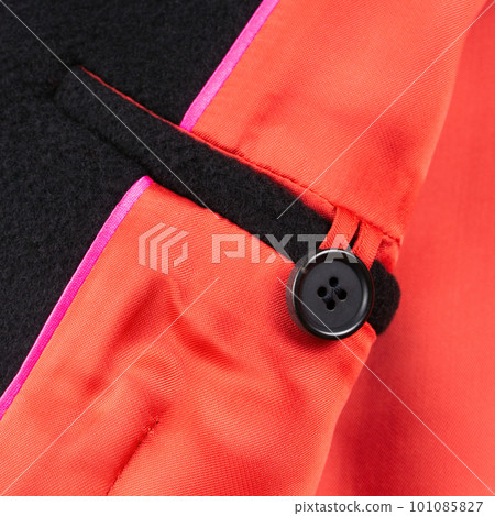 Interior button pocket in black wool coat with bright red lining. Close up Interior button pocket in black wool coat with bright red lining. Close up 101085827
