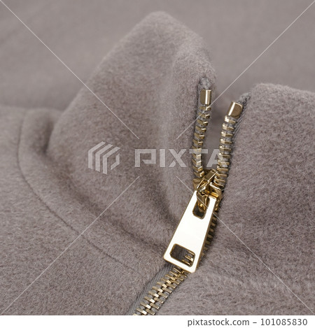 Stand collar beige cashmere coat with golden zip. Close up Stand collar beige cashmere coat with golden zip. Close up 101085830