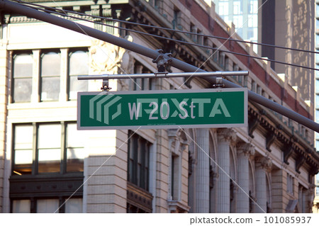 Green big West 20th Street sign hanging on a arch pole in the streets of midtown Manhattan 101085937