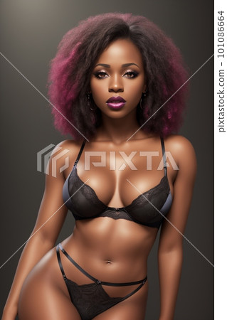 Sexy young African American woman in a black bra stands in front of a lit up wall 101086664