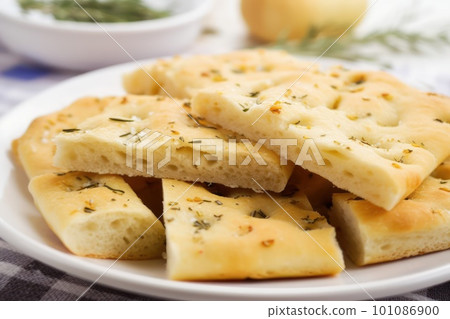 Appetizing sliced roman focaccia on white saucer 101086900