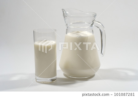 Glass and jug of fresh milk on a gray background. Dairy product Glass and jug of fresh milk on a gray background. Dairy product 101087281