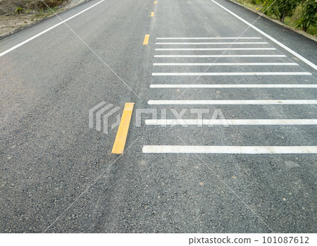 The white transverse rumble strips on the asphalt road. The white transverse rumble strips on the asphalt road. 101087612