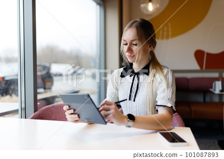 The girl works and studies with a graphic tablet 101087893