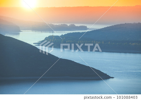Beautiful evening landscape. River with rocky hills at sunset in autumn. Beautiful nature Beautiful evening landscape. River with rocky hills at sunset in autumn. Beautiful nature 101088403