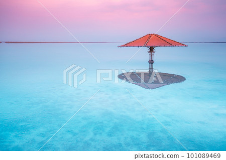 Dead Sea beach. Sun umbrella in water. Minimalist landscape Dead Sea beach. Sun umbrella in water. Minimalist landscape 101089469