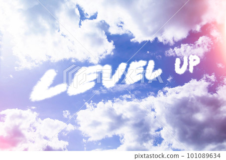Level up. Text from clouds in sky in bright sunlight. Level up. Text from clouds in sky in bright sunlight. 101089634