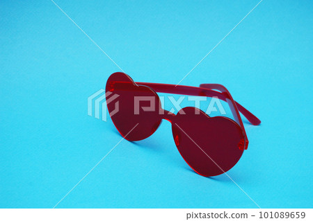 Women's red sunglasses on a blue background. Women's red sunglasses on a blue background. 101089659