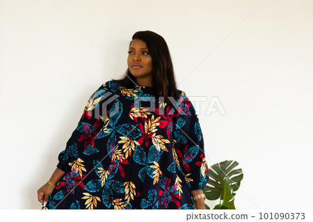 Portrait of african american woman smiling against white wall in room - inclusion and diversity concept. copy space and empty space for text or advertising 101090373