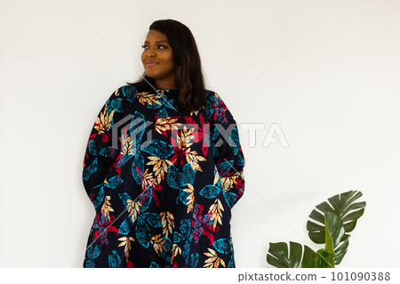 Portrait of african american woman smiling against white wall in room - inclusion and diversity concept. copy space and empty space for text or advertising 101090388