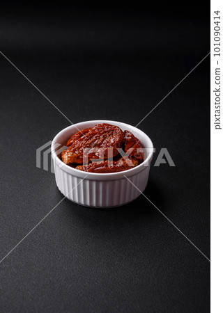 Delicious sun dried tomatoes in oil in a white ceramic bowl Delicious sun dried tomatoes in oil in a white ceramic bowl 101090414