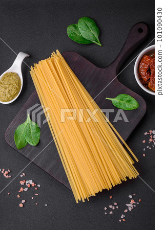 Delicious pasta with spinach, sun dried tomatoes, cheese, onions 101090430