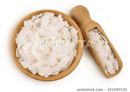 Coconut flakes or chips in wooden bowl isolated on white background. Top view. Flat lay Coconut flakes or chips in wooden bowl isolated on white background. Top view. Flat lay 101090530