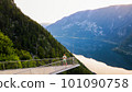 Young man standing on the viewing platform with drone controller view of Hallstatt lake, mountains 101090758