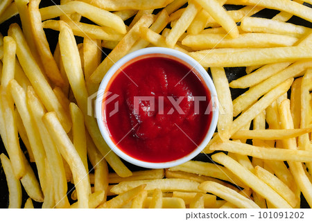 Tasty french fries and ketchup close-up. Background, top view Tasty french fries and ketchup close-up. Background, top view 101091202