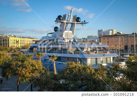 Large yacht in an urban environment on a sunny day. Embankment with palm trees and a boat close-up. Large yacht in an urban environment on a sunny day. Embankment with palm trees and a boat close-up. 101091218