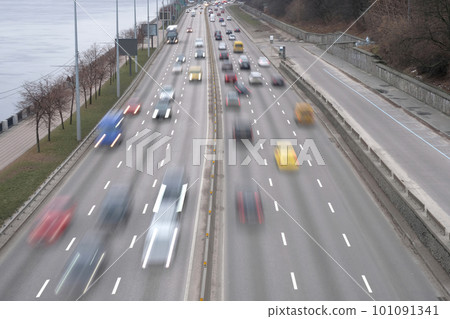 Cars blurred in motion at speed. Evening traffic, cars on the highway in the city 101091341