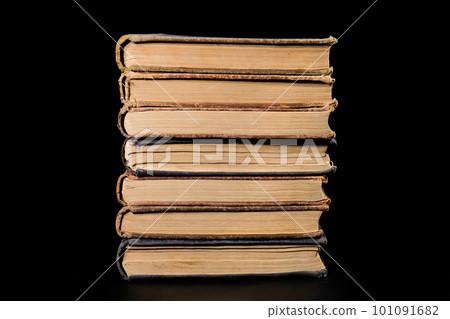 A stack of old books isolated on a black background, close-up. Education, training A stack of old books isolated on a black background, close-up. Education, training 101091682