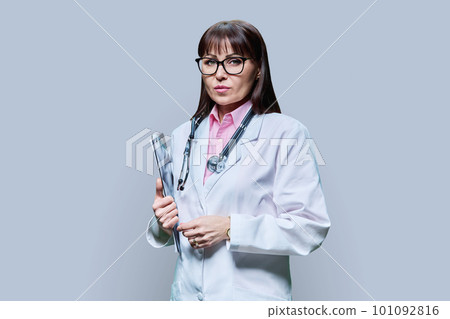 Portrait of serious female doctor on gray background Portrait of serious female doctor on gray background 101092816