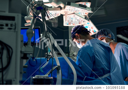 Group of surgeons doing surgery in hospital operating theater. Medical team doing critical operation. 101093188