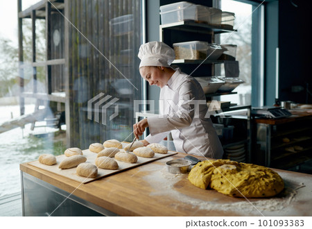 Baker engaged in making of traditional yeast buns with cheese 101093383