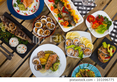 Top view of dishes from trout and mollusks 101096775