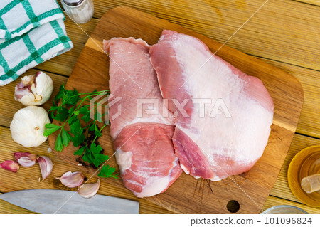 Spanish Secreto de cerdo - raw pork cinch with parsley and peppers in plate 101096824