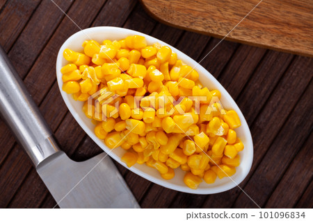 Close up of preserved maize in plate on table 101096834