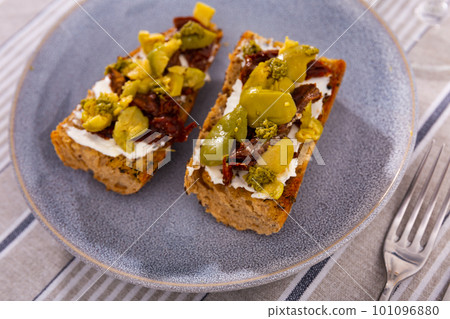 Sandwich with cheese, sun-dried tomatoes and olives closeup Sandwich with cheese, sun-dried tomatoes and olives closeup 101096880