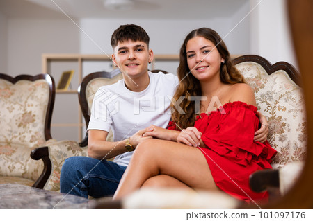 Portrait of loving family couple sitting in comfy home room Portrait of loving family couple sitting in comfy home room 101097176