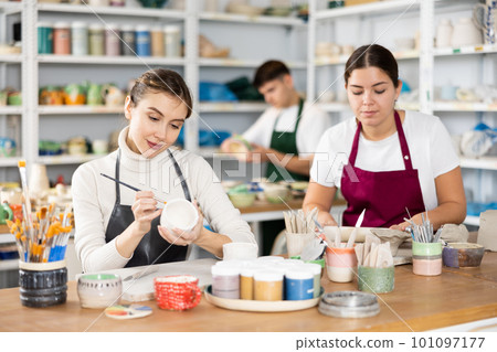 Two young women making pottery in workshop Two young women making pottery in workshop 101097177