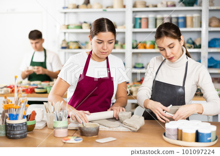 Two young women making pottery in workshop Two young women making pottery in workshop 101097224