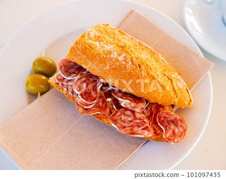 Sandwich with delicious delicaty dried sausage Fuet Sandwich with delicious delicaty dried sausage Fuet 101097435