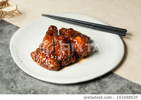 Deep-fried chicken with korean style sauce on white plate. Deep-fried chicken with korean style sauce on white plate. 101098020