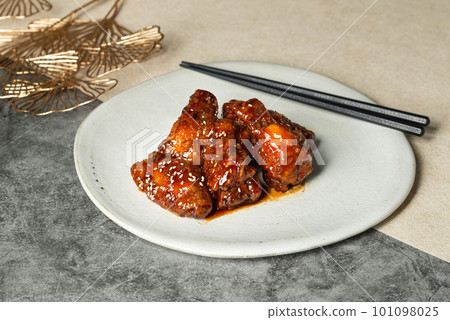 Deep-fried chicken with korean style sauce on white plate. Deep-fried chicken with korean style sauce on white plate. 101098025