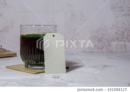Blue-green algae Chlorella and spirulina powder drink with empty paper note copy space. Super powder. Natural supplement of algae. Detox superfood drink cocktail. Food supplement source of protein and Blue-green algae Chlorella and spirulina powder drink with empty paper note copy space. Super powder. Natural supplement of algae. Detox superfood drink cocktail. Food supplement source of protein and 101098127