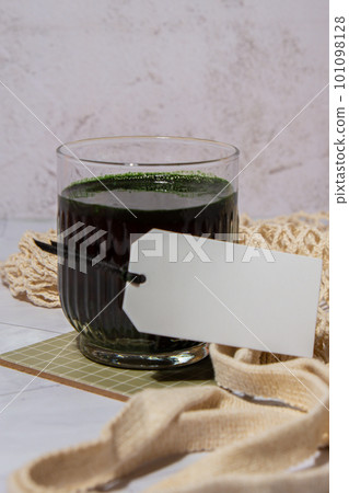 Blue-green algae Chlorella and spirulina powder drink with empty paper note copy space. Super powder. Natural supplement of algae. Detox superfood drink cocktail. Food supplement source of protein and 101098128