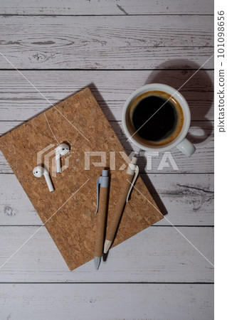 Top view, wooden Office desk with cup of coffee, eco pen, wireless headphones and recycle notebook. Business or student workspace concept Flat lay. Personal diary Audio healing, sound mental health Top view, wooden Office desk with cup of coffee, eco pen, wireless headphones and recycle notebook. Business or student workspace concept Flat lay. Personal diary Audio healing, sound mental health 101098656