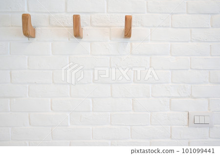 wooden hanger hook on white brick wall wooden hanger hook on white brick wall 101099441