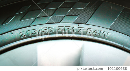 Numbers and characters on the sidewall of a car tire. 101100688