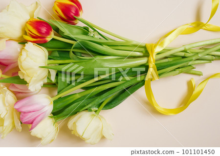 A bright spring bouquet of tulips on a beige background. Greeting card A bright spring bouquet of tulips on a beige background. Greeting card 101101450