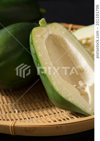 Green papaya cut side served in a colander Green papaya cut side served in a colander 101101706