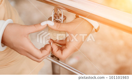 Hands, lock, heart, love, valentines day. Close-up of a woman's hands holding heart shaped padlock with a heart. The concept of Valentine's day, wedding, symbol of love and fidelity. 101101983